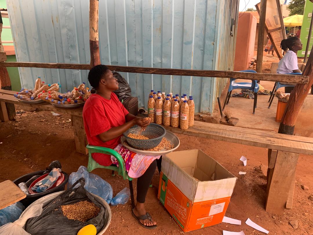 Young woman processing groundnuts